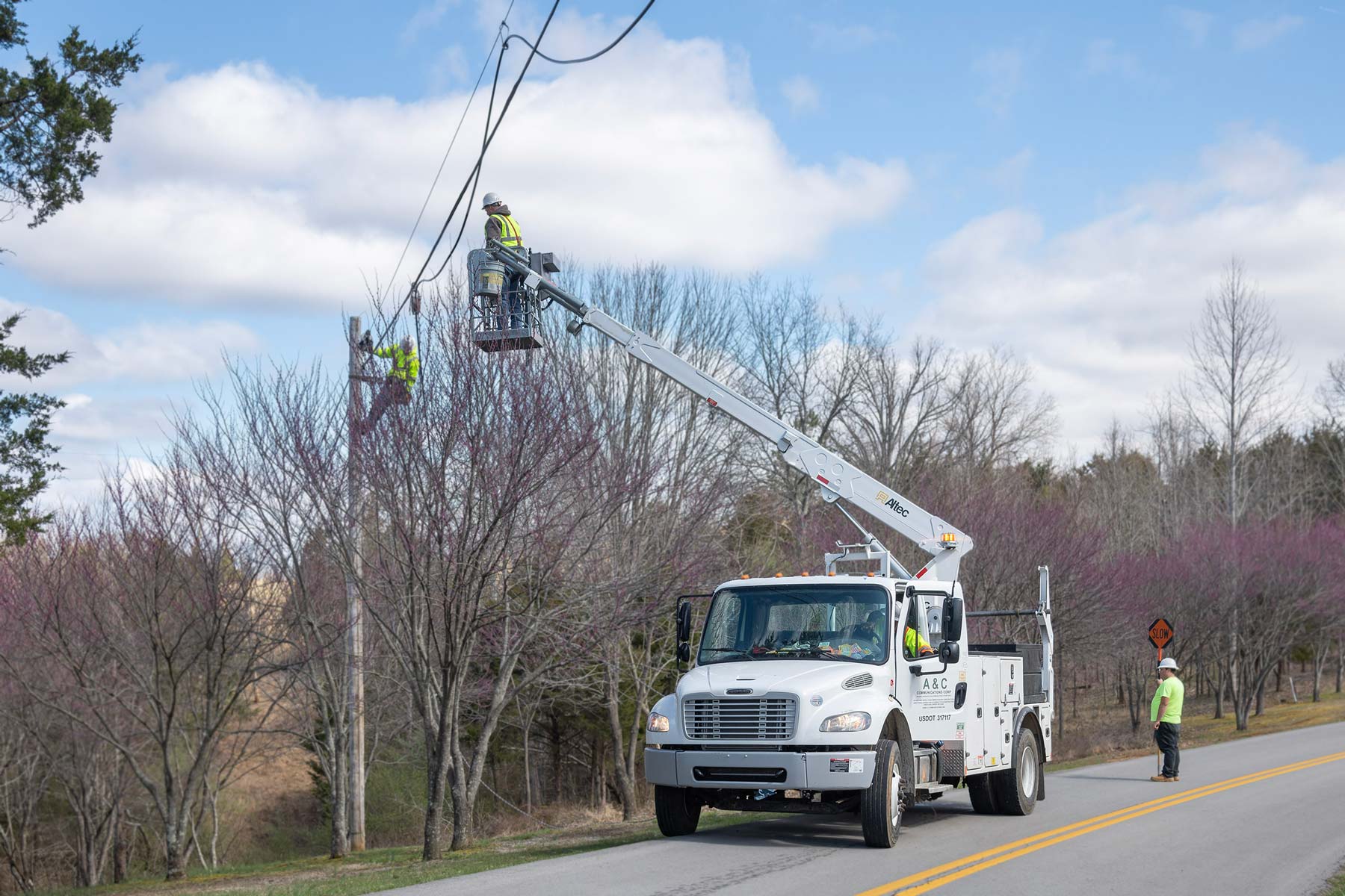 DUO Broadband contractors installing fiber optic cable in a rural area.
