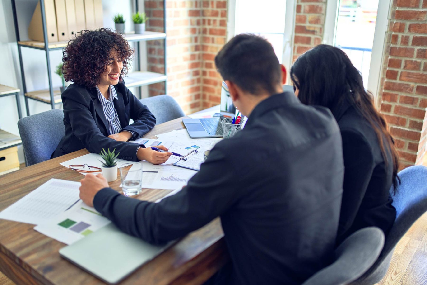 loan officer working with young couple in small office