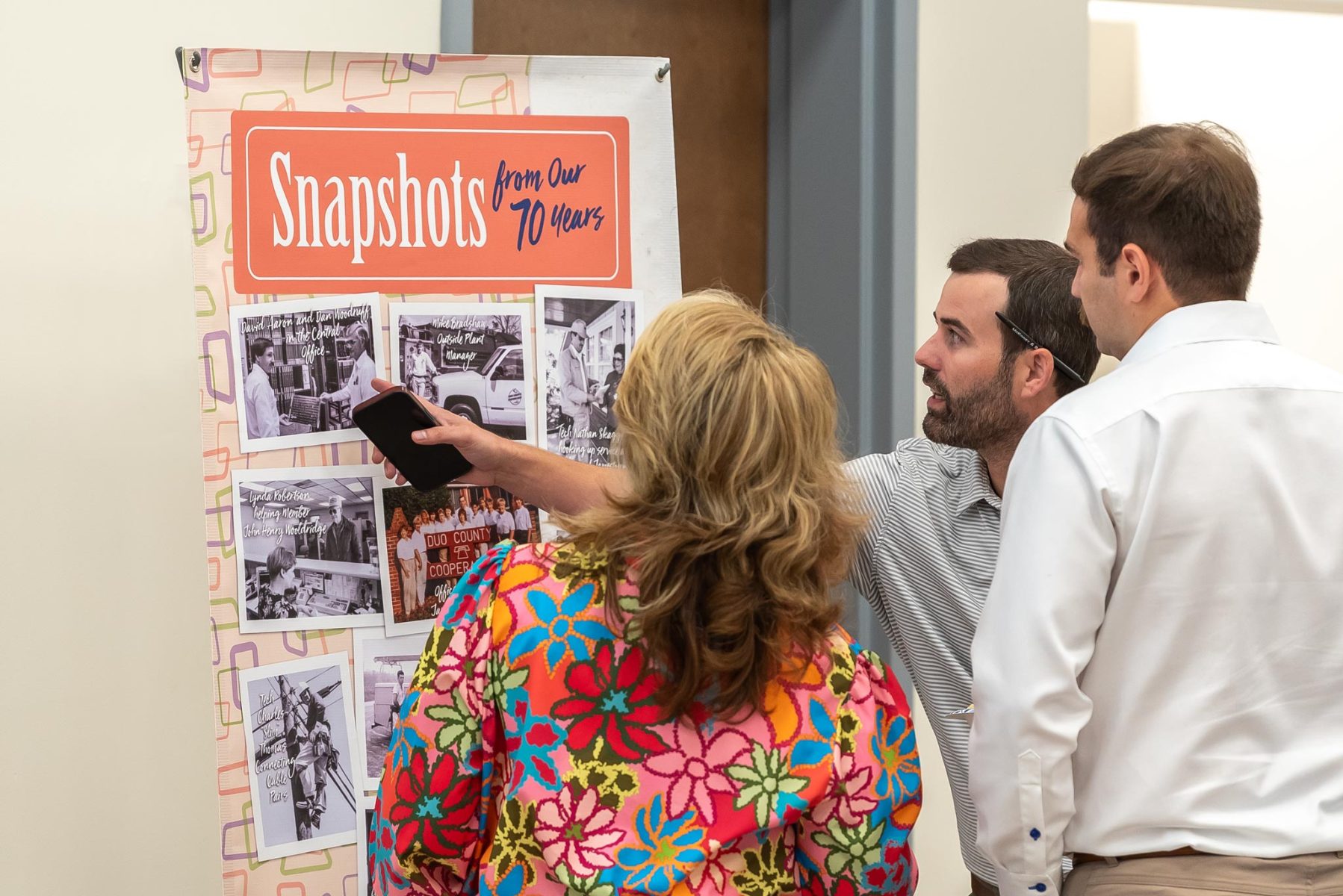 People looking at a display of historic photographs