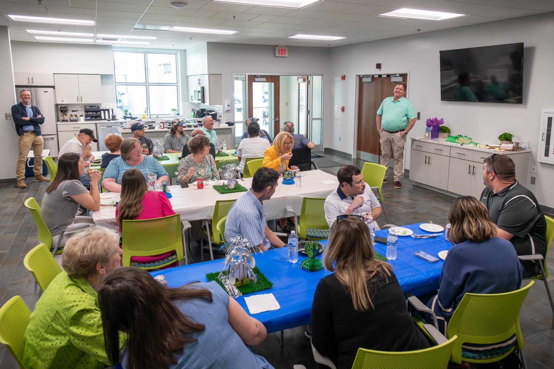 Group of people having cake at retirement lunch